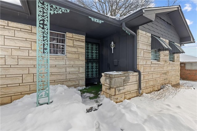 view of snow covered property entrance