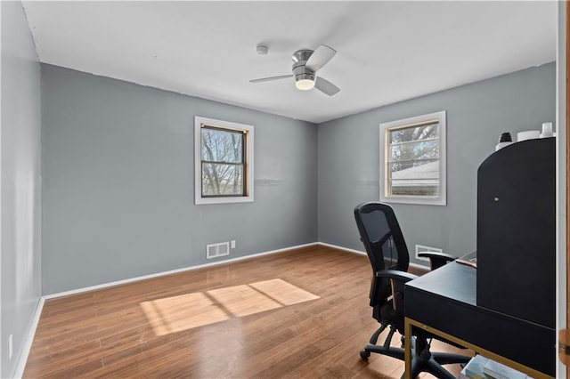 office space featuring hardwood / wood-style flooring, ceiling fan, and plenty of natural light