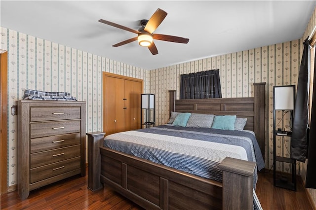 bedroom with dark hardwood / wood-style flooring, a closet, and ceiling fan