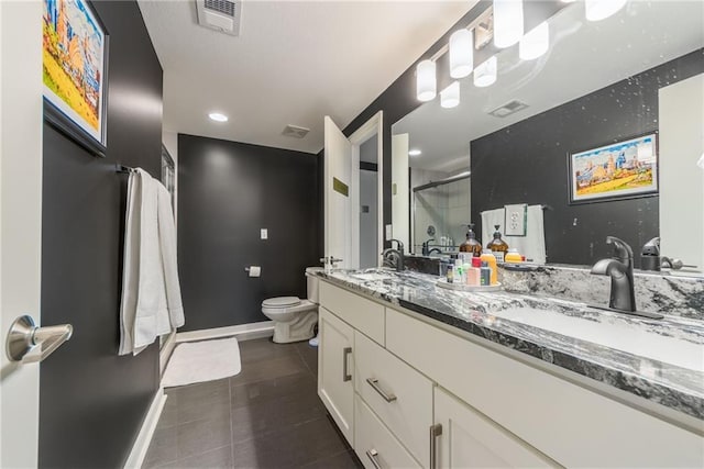 bathroom featuring tile patterned floors, toilet, a shower with shower door, and vanity