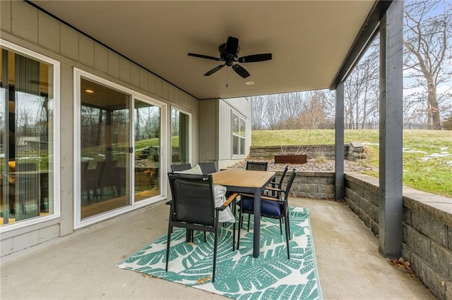 sunroom / solarium featuring ceiling fan