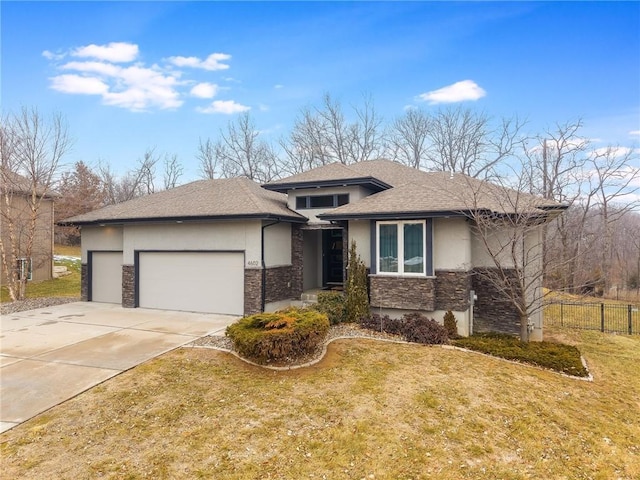 prairie-style home featuring a garage and a front yard