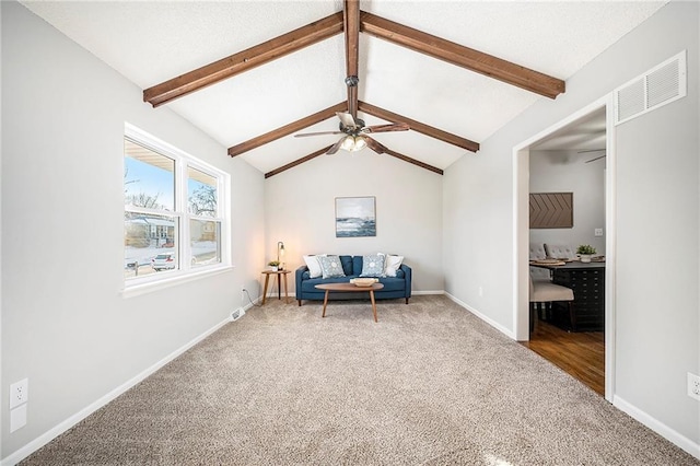 living area with carpet floors, ceiling fan, and vaulted ceiling with beams