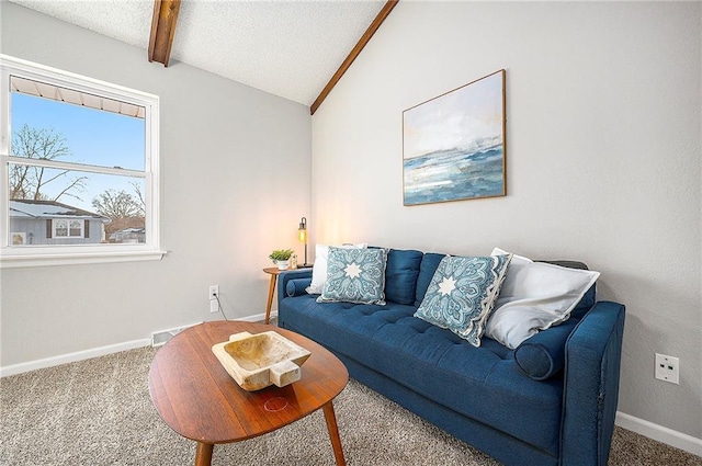 carpeted living room with a textured ceiling and lofted ceiling with beams