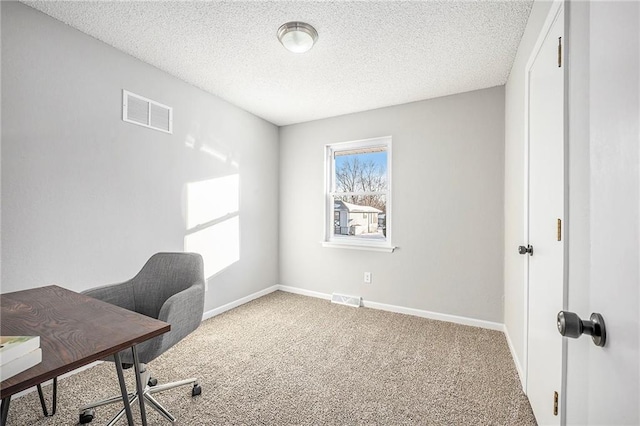 office space with plenty of natural light, a textured ceiling, and carpet