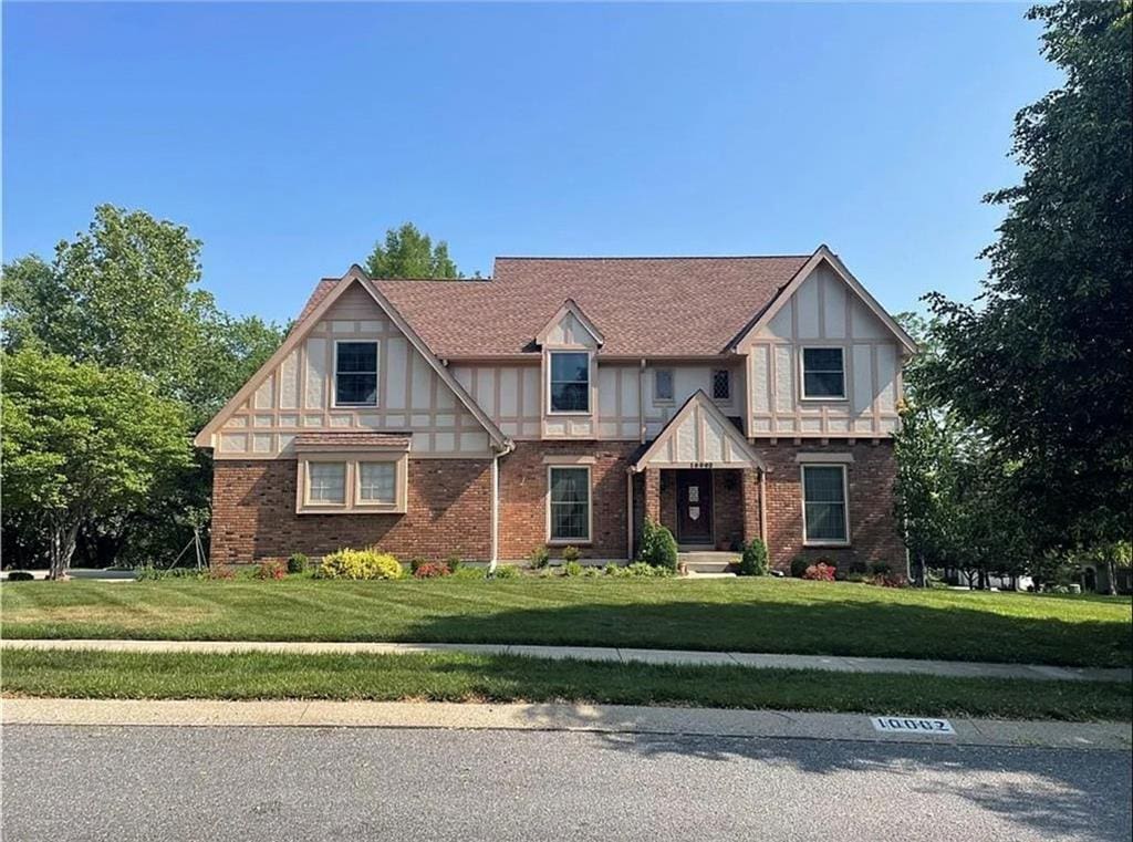 tudor house featuring a front lawn