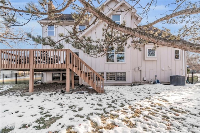 snow covered property featuring a wooden deck