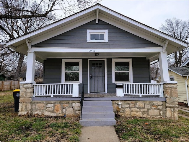 view of front facade with fence and a porch