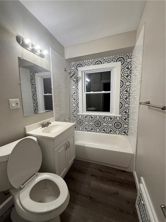 bathroom featuring toilet, visible vents, wood finished floors, and vanity