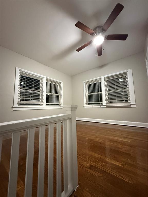 interior space featuring dark wood-type flooring and baseboards