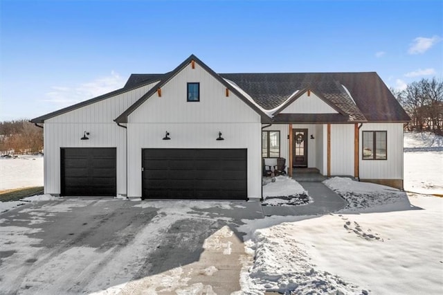 modern inspired farmhouse with a garage