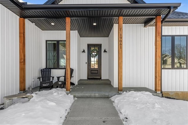 view of snow covered property entrance