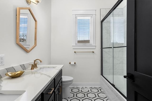 full bathroom featuring toilet, bath / shower combo with glass door, tile patterned floors, and vanity