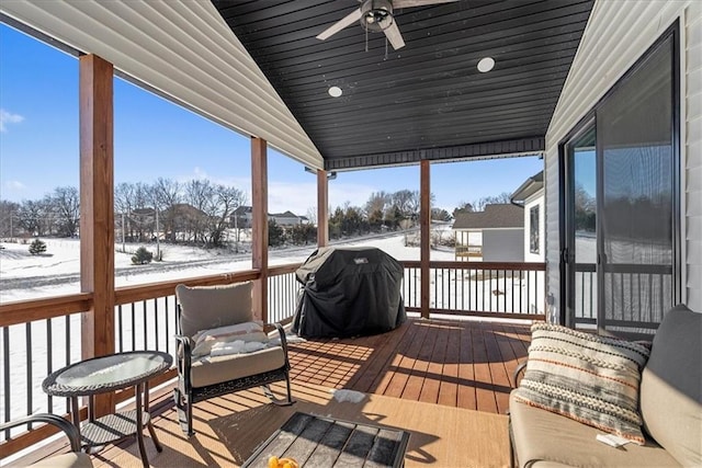 sunroom / solarium with ceiling fan and vaulted ceiling