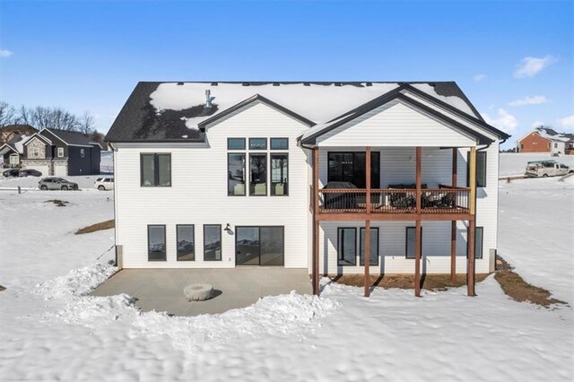 view of snow covered back of property