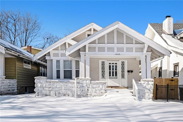 view of snow covered back of property