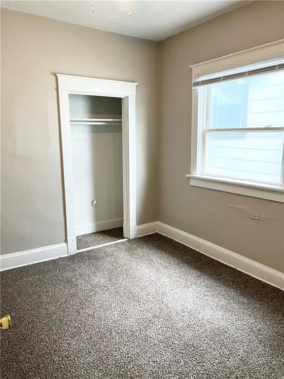 unfurnished bedroom featuring carpet flooring and a closet