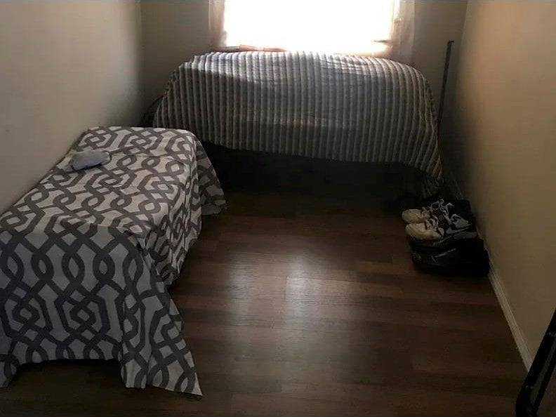 bedroom with dark hardwood / wood-style flooring