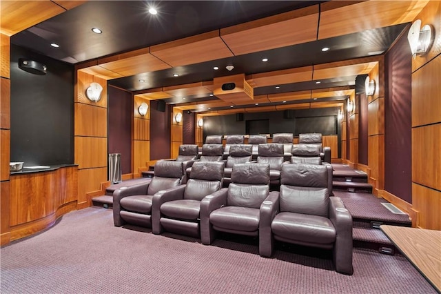 carpeted cinema featuring wood walls