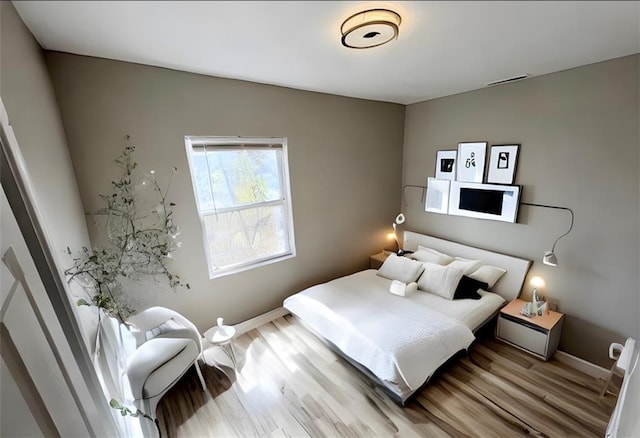 bedroom with hardwood / wood-style flooring