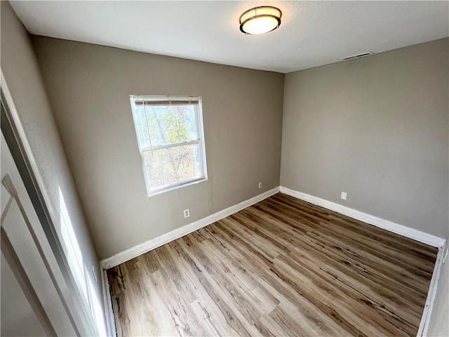 empty room with wood-type flooring