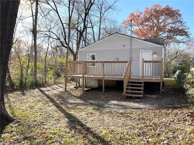 back of house with a deck