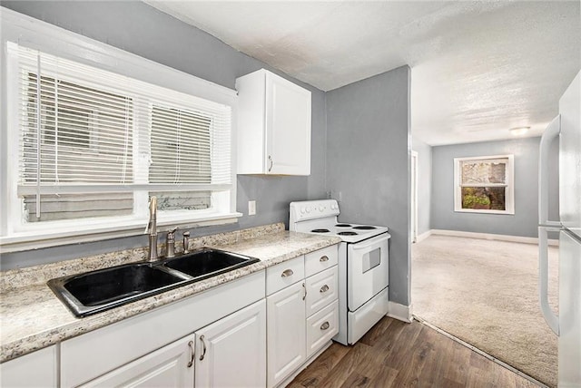 kitchen featuring dark hardwood / wood-style flooring, sink, white appliances, and white cabinets