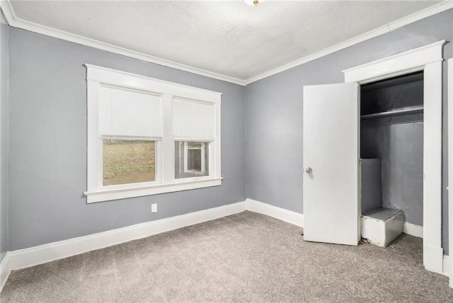 unfurnished bedroom with crown molding, carpet floors, a closet, and a textured ceiling