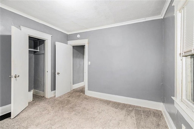 unfurnished bedroom featuring crown molding, light colored carpet, and a closet