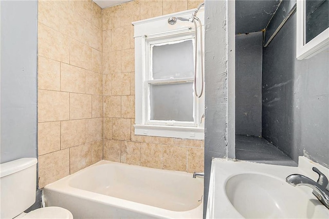 full bathroom with bathing tub / shower combination, sink, and toilet