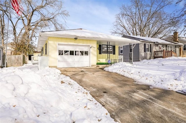 ranch-style house featuring covered porch and a garage