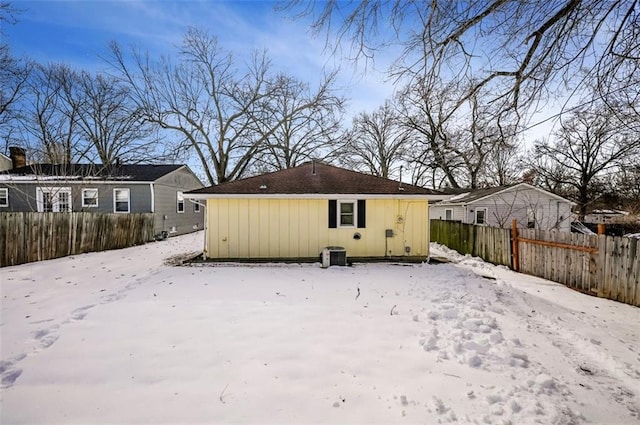 view of snow covered rear of property