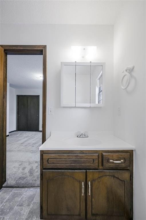 bathroom featuring vanity and a textured ceiling