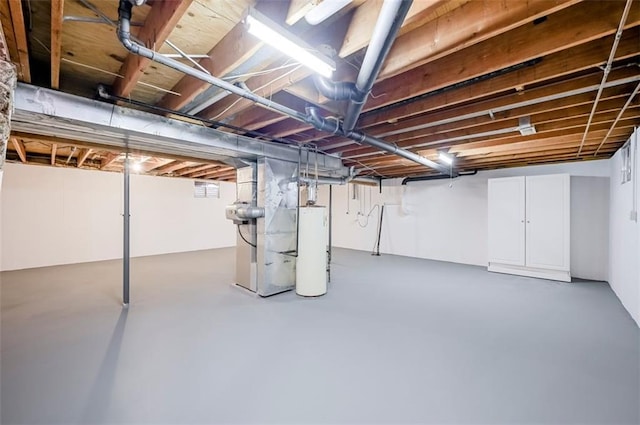 basement with water heater and heating unit