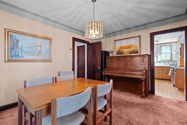 dining room with light carpet, an inviting chandelier, and ornamental molding