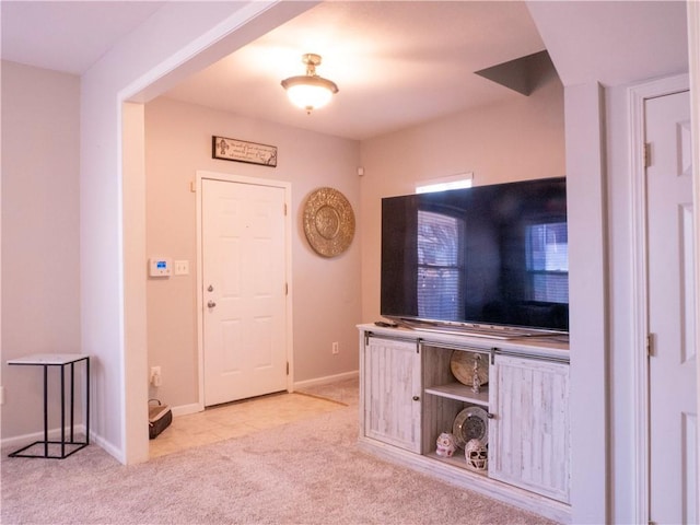 foyer entrance featuring light carpet