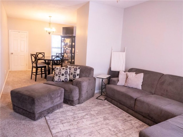 carpeted living room featuring a notable chandelier