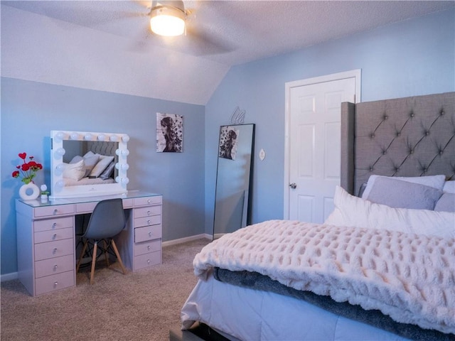 bedroom featuring lofted ceiling, light carpet, a textured ceiling, and ceiling fan