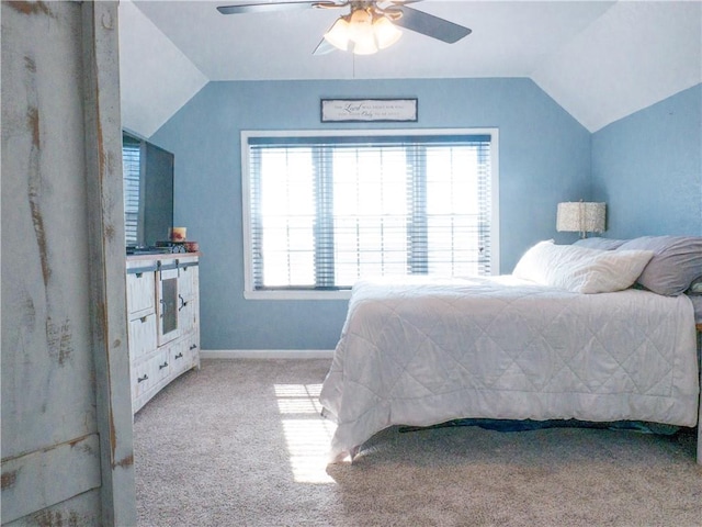 bedroom with vaulted ceiling, light colored carpet, and ceiling fan