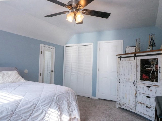 carpeted bedroom with ceiling fan and vaulted ceiling