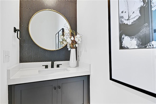 bathroom with wallpapered walls and vanity