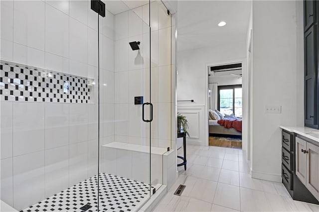 ensuite bathroom featuring tile patterned flooring, connected bathroom, a shower stall, and vanity