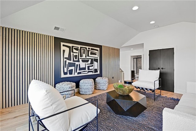 living area with lofted ceiling, visible vents, wood finished floors, and recessed lighting