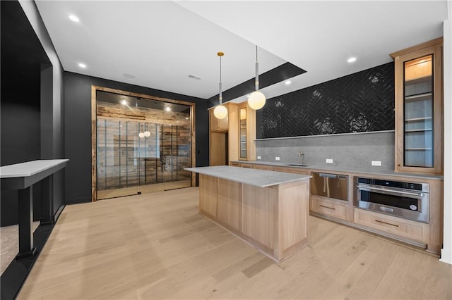 bar featuring light wood finished floors, oven, a warming drawer, backsplash, and recessed lighting