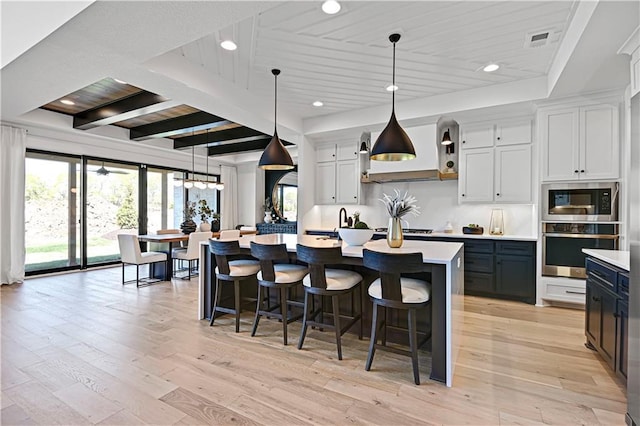 16920 Parkhill St, Overland Park, KS 66221 - kitchen featuring stainless steel appliances, light countertops, healthy amount of natural light, wooden ceiling with exposed beams, and recessed lighting