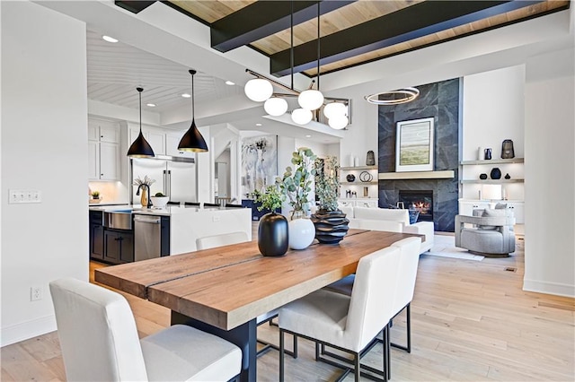 16920 Parkhill St, Overland Park, KS 66221 - dining area with a fireplace, light wood-style flooring, baseboards, wood ceiling with exposed beams, and recessed lighting