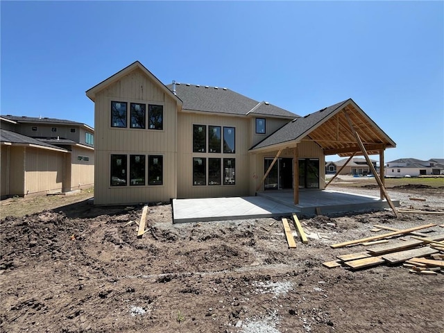 16920 Parkhill St, Overland Park, KS 66221 - back of property with a patio and roof with shingles