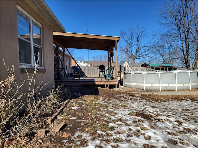 yard covered in snow featuring a swimming pool side deck