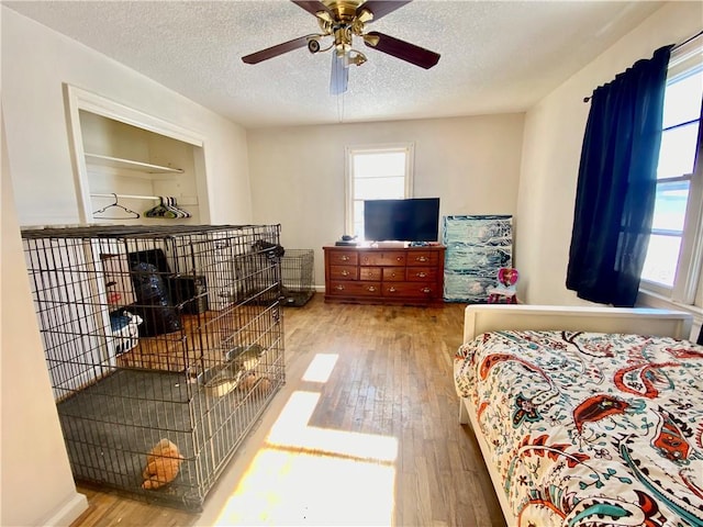 bedroom with hardwood / wood-style floors and a textured ceiling