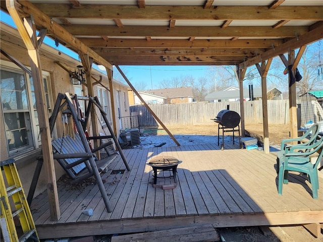 wooden terrace featuring an outdoor fire pit